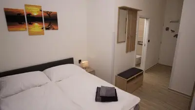 a bedroom with a white bed and a bathroom at Apartment CONTINENTS nearby Main Train and Bus Station in Prague