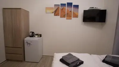a room with a bed and a small refrigerator at Apartment CONTINENTS nearby Main Train and Bus Station in Prague