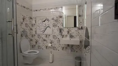 a bathroom with a toilet and a sink and a mirror at Apartment CONTINENTS nearby Main Train and Bus Station in Prague