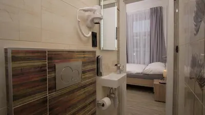 a bathroom with a shower and a sink and a bed at Apartment CONTINENTS nearby Main Train and Bus Station in Prague