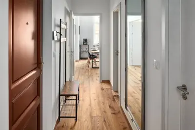 a hallway with a table and chairs in a room at Prague Days - One-bedroom Apartment with Workspace by Vltava River in Smíchov in Prague