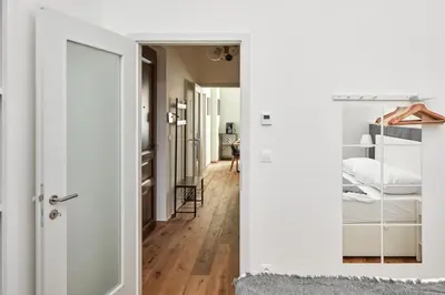a hallway with a door leading to a bedroom at Prague Days - One-bedroom Apartment with Workspace by Vltava River in Smíchov in Prague