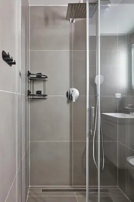a shower with a glass door in a bathroom at Prague Days - One-bedroom Apartment with Workspace by Vltava River in Smíchov in Prague