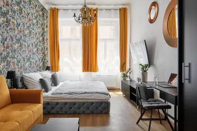 a bedroom with a bed and a desk at Prague Days - Sunlit 1BDR Apartments w Netflix in New Town in Prague