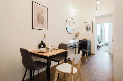 a dining room with a table and chairs at Prague Days - Sunlit 1BDR Apartments w Netflix in New Town in Prague