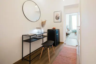 a room with a table and a mirror and a stool at Prague Days - Sunlit 1BDR Apartments w Netflix in New Town in Prague