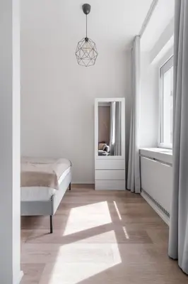 a bathroom with a white toilet and a mirror at Prague Days - One-bedroom Apartment with Courtyard View in Karlín in Prague