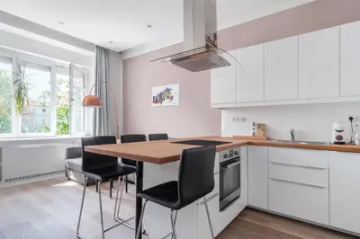 a white bedroom with a bed and a window at Prague Days - One-bedroom Apartment with Courtyard View in Karlín in Prague