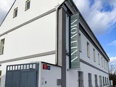 a sign on the side of a building with a garage at Penzion MOVEINN in Prague