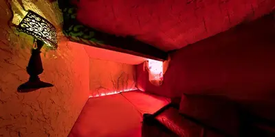 a red lighted room with a red floor and a staircase at Afrodita Wellness Apartman Prague in Prague