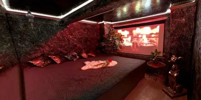 a room with a red bed with a stuffed animal on it at Afrodita Wellness Apartman Prague in Prague