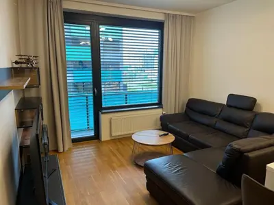 a living room with a couch and a table at Apartman Holesovice,balkon,garaz in Prague