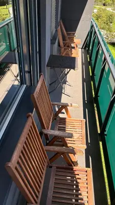 a row of wooden benches sitting on the side of a building at Apartman Holesovice,balkon,garaz in Prague