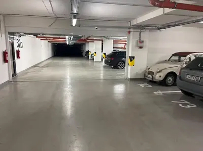 a parking garage with cars parked in it at Apartman Holesovice,balkon,garaz in Prague