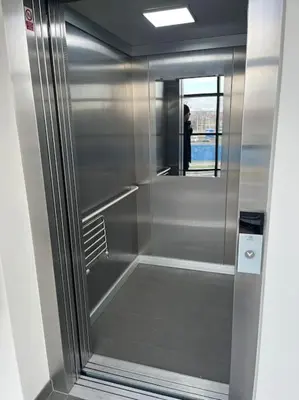 a glass shower in a bathroom with a person in the mirror at Apartman Holesovice,balkon,garaz in Prague