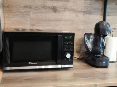 a microwave sitting on a counter next to a blender at Vibe House Prague in Prague