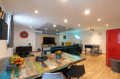 a living room with a table and a couch at Vibe House Prague in Prague