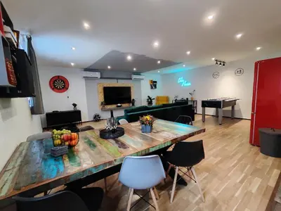 a living room with a large wooden table and chairs at Vibe House Prague in Prague