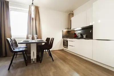 a kitchen with a table and chairs in a room at Apartments / 10 min from center / O2 ARENA in Prague