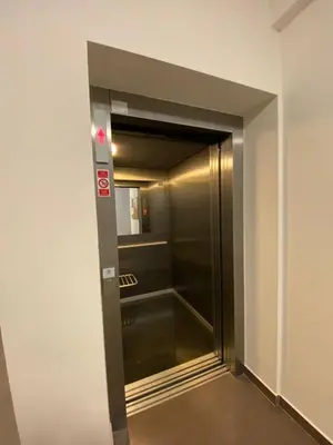 a elevator in a building with a glass door at Apartments / 10 min from center / O2 ARENA in Prague