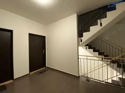 an empty room with a staircase and a door at Apartments / 10 min from center / O2 ARENA in Prague