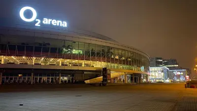 a large building with a sign on it at night at Apartments / 10 min from center / O2 ARENA in Prague