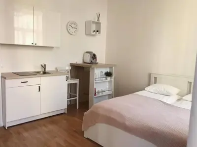 a bedroom with a bed and a kitchen with a sink at Favorite apartment in the center of Prague 1 in Prague
