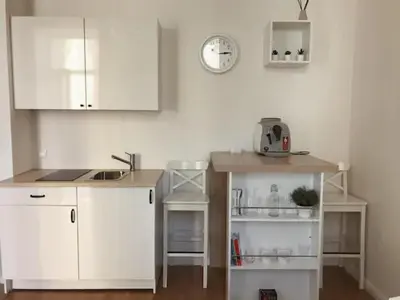 a kitchen with white cabinets and a counter top at Favorite apartment in the center of Prague 1 in Prague