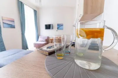 a glass pitcher and two glasses on a table at Favorite apartment in the center of Prague 1 in Prague