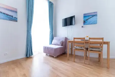 a living room with a table and a chair at Favorite apartment in the center of Prague 1 in Prague
