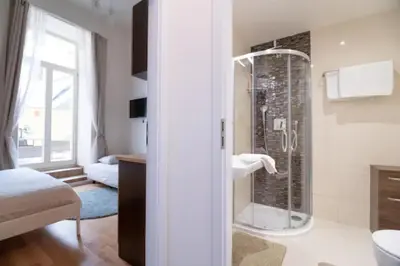 a bathroom with a shower in the corner of a room at Favorite apartment in the center of Prague 1 in Prague