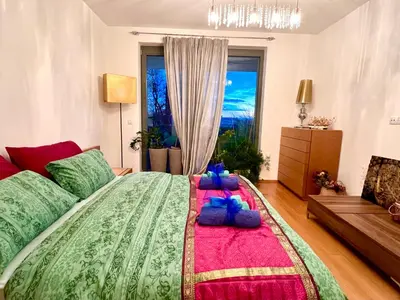a bedroom with a large bed with pillows on it at Romantic stay overlooking Prague in Prague