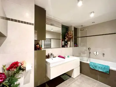 a bathroom with a white sink and a bath tub at Romantic stay overlooking Prague in Prague