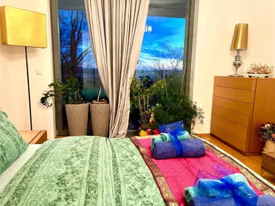 a bedroom with a bed and a large window at Romantic stay overlooking Prague in Prague