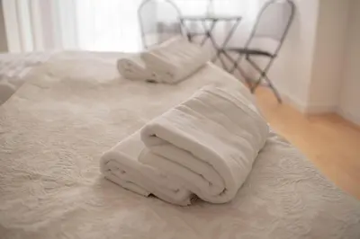 a pile of towels sitting on top of a bed at Rezidence Kbely - Free Parking in Prague