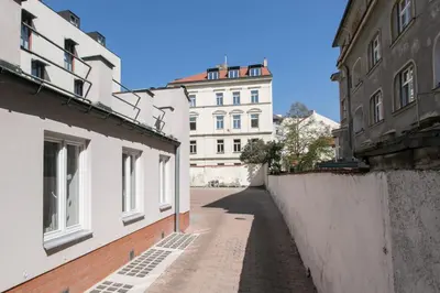 an alley between two buildings with a building in the background at Cozy apartment in quiet courtyard near Charles Bridge in Prague