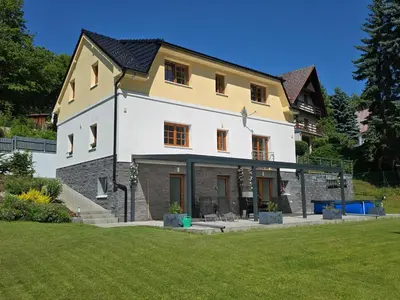 a white and yellow house in the snow at Holiday Home Posázaví by Interhome in Jílové u Prahy