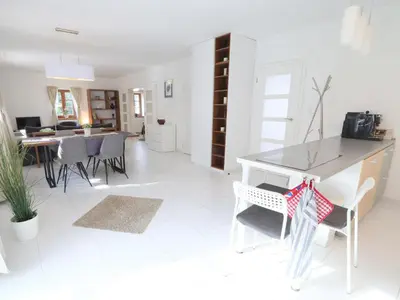 a white kitchen with a refrigerator and chairs at Holiday Home Posázaví by Interhome in Jílové u Prahy