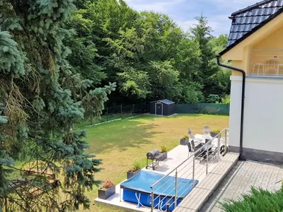 a large white and yellow house with a yard at Holiday Home Posázaví by Interhome in Jílové u Prahy