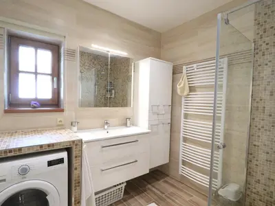 a bathroom with a sink and a washing machine at Holiday Home Posázaví by Interhome in Jílové u Prahy