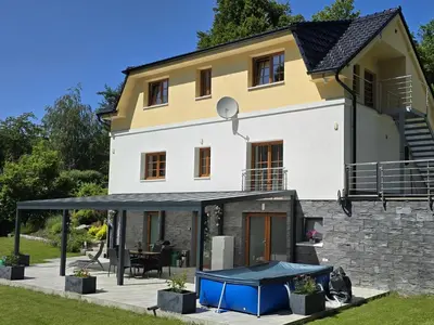 a living room with a couch and a table at Holiday Home Posázaví by Interhome in Jílové u Prahy