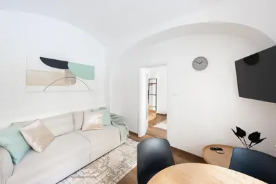 a living room with a white couch and a table at George Apartment in Prague