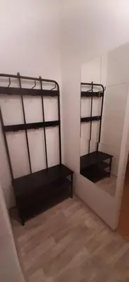 a room with two black bunk beds and a wooden floor at Apartman Josef in Prague