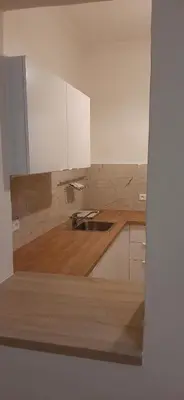 a kitchen with white cabinets and a sink at Apartman Josef in Prague
