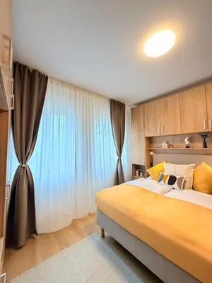 a bedroom with a large bed and a large window at Parkside Apartments Prague in Prague