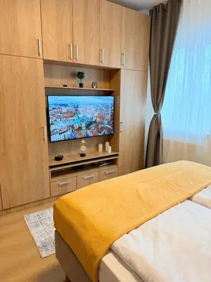a bedroom with a bed and a flat screen tv at Parkside Apartments Prague in Prague