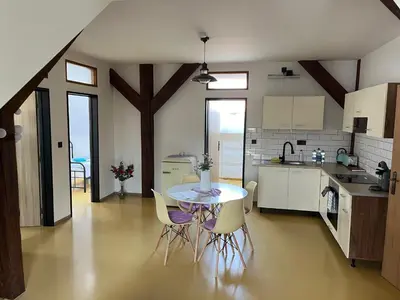 a kitchen and dining room with a table and chairs at Zelený grunt in Dřínov
