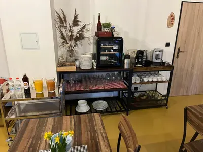 a coffee shop with two tables and a coffee machine at Zelený grunt in Dřínov