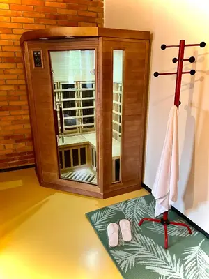 a room with a shower with a towel and shoes at Zelený grunt in Dřínov