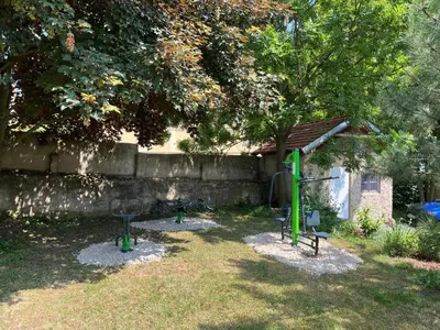 a backyard with a playground with a tree and a building at Zelený grunt in Dřínov